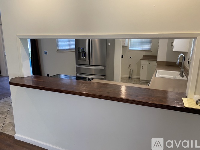 A kitchen with a stainless steel refrigerator and oven.