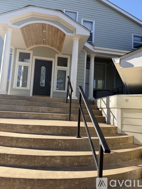 A house with a front porch and stairs leading up to it.