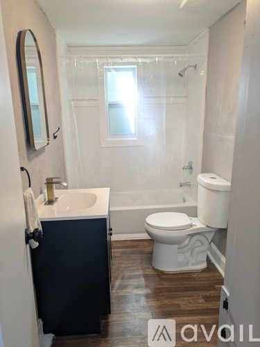 A bathroom with a sink, toilet, and bathtub.