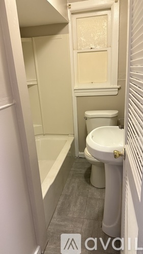 A small bathroom with a toilet and a bathtub.