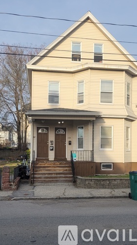 A two-story house with a brown door and white trim.