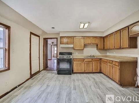 A kitchen with wooden cabinets and a black oven.