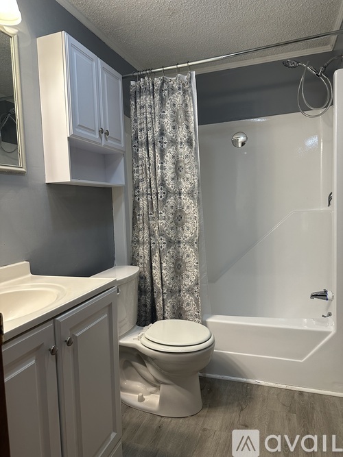 A bathroom with a toilet, sink, and bathtub.