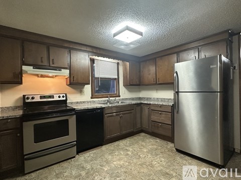 A kitchen with a stove, oven, and refrigerator.