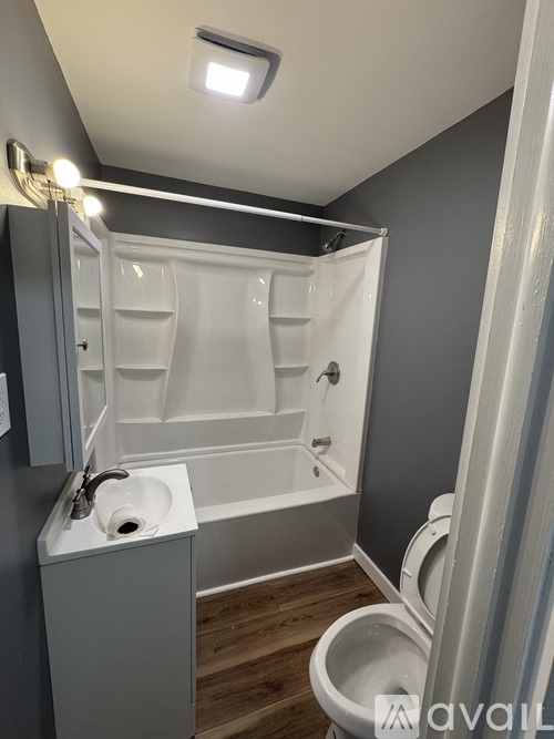 A bathroom with a toilet, sink, and bathtub.
