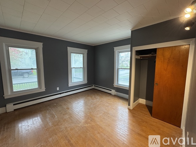 A room with wooden floors and grey walls.