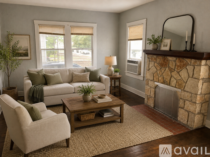 A living room with a stone fireplace and a beige sofa.