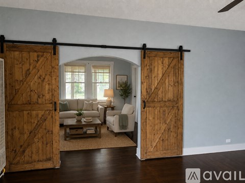 A room with a sliding barn door and a couch.