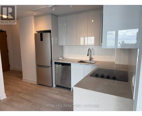 A kitchen with a stainless steel refrigerator and dishwasher.