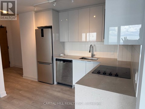 A kitchen with a stainless steel refrigerator and dishwasher.