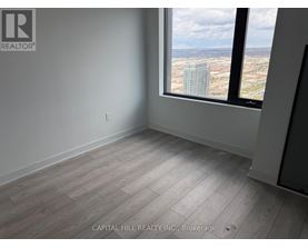 A room with a large window overlooking a cityscape.