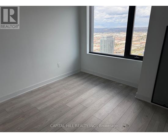 A room with a large window overlooking a cityscape.