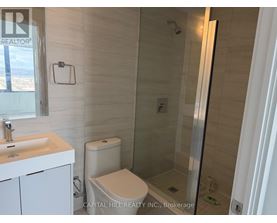 A white sink and toilet in a small bathroom.