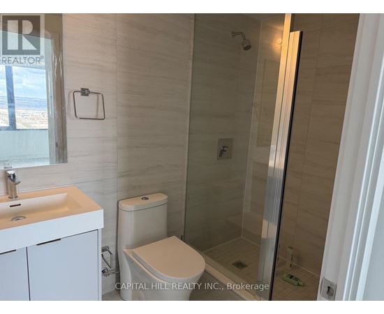 A white sink and toilet in a small bathroom.