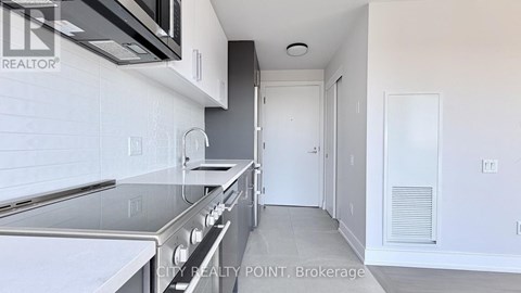 A kitchen with a stainless steel oven and microwave above it.