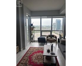 A living room with a couch, chair, and coffee table.