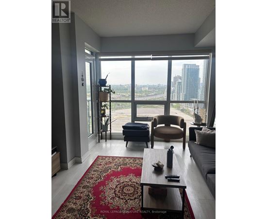 A living room with a couch, chair, and coffee table.