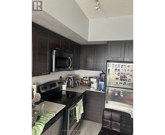 A kitchen with black cabinets and a black counter top.