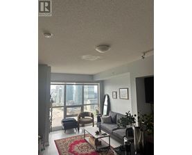 A living room with a couch, chair, and a coffee table.