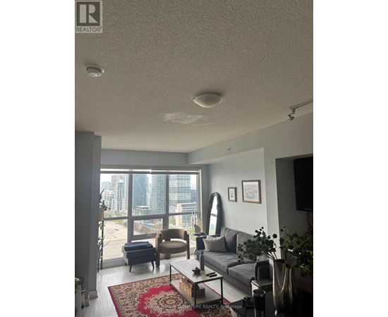 A living room with a couch, chair, and a coffee table.