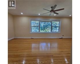 A room with a ceiling fan and a window.