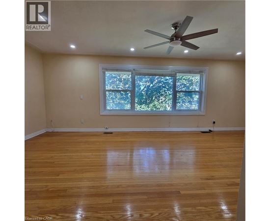 A room with a ceiling fan and a window.