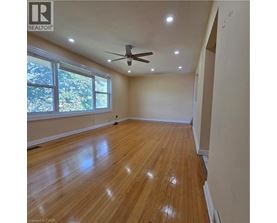 A room with wooden flooring and a ceiling fan.