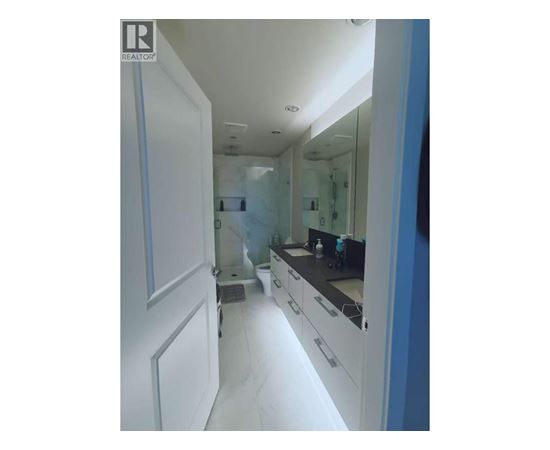 A bathroom with a sink and mirror.