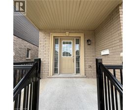 A beige door is the centerpiece of this front porch.