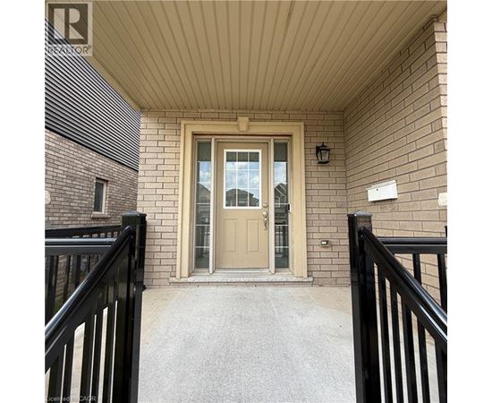A beige door is the centerpiece of this front porch.