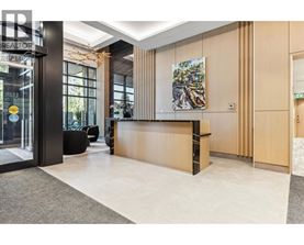 A reception area with a wooden counter and a painting on the wall.