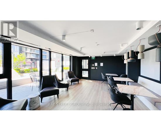 A conference room with black chairs and a white table.