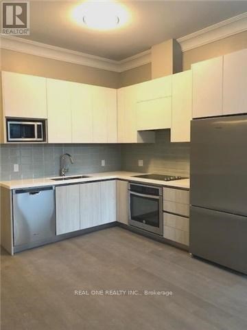 A kitchen with white cabinets and stainless steel appliances.