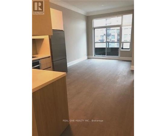 A realtor photo of a kitchen and living room.