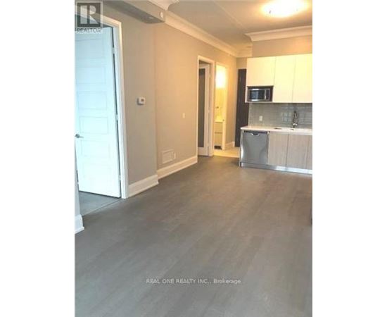 A kitchen area with a microwave, dishwasher, and cabinets.