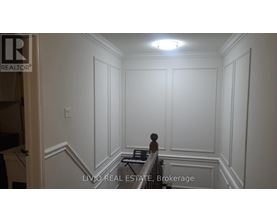A room with white walls and a piano in the corner.