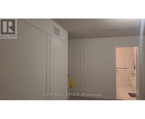 A white door with a yellow sign on it.