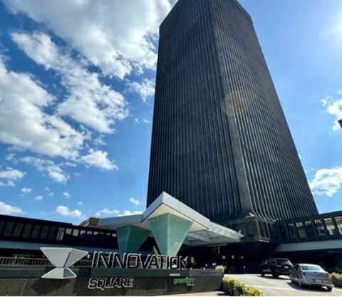 A tall building with the words "Innovation Square" on its facade.