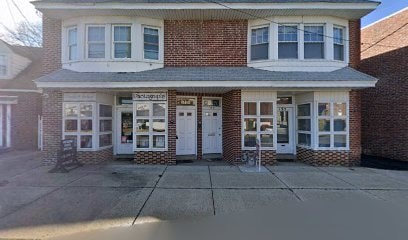 A two-story brick house with a white door and windows.