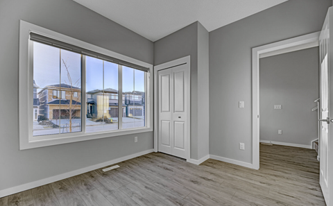 A room with a large window overlooking a snowy landscape.