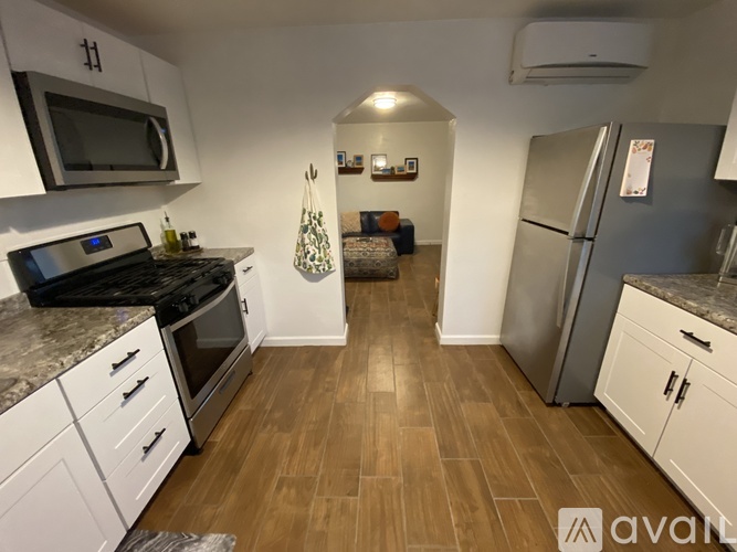 A kitchen with white cabinets and a black stove top oven.