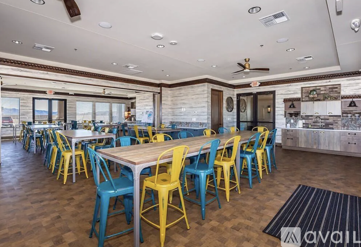 A dining room with wooden tables and blue chairs.