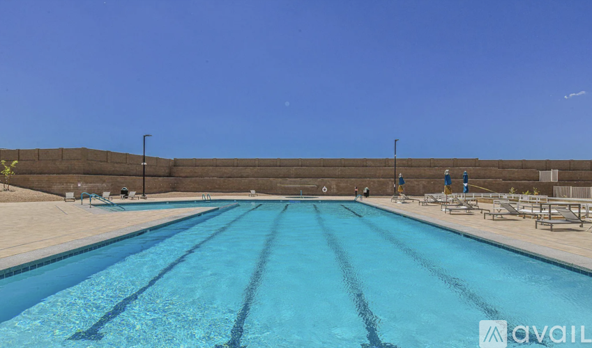 A large outdoor swimming pool with lanes marked for swimming.