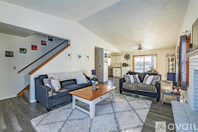 A living room with a grey couch and a wooden coffee table.