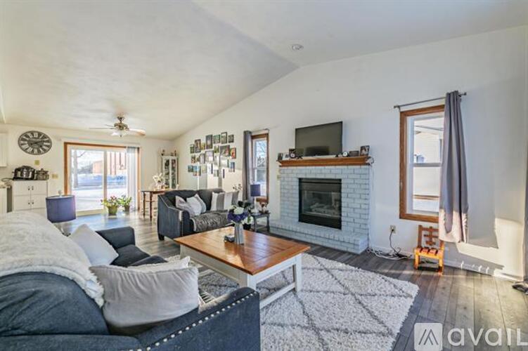 A living room with a fireplace and a television.