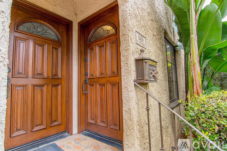 A pair of wooden doors with glass panels and a metal handle.