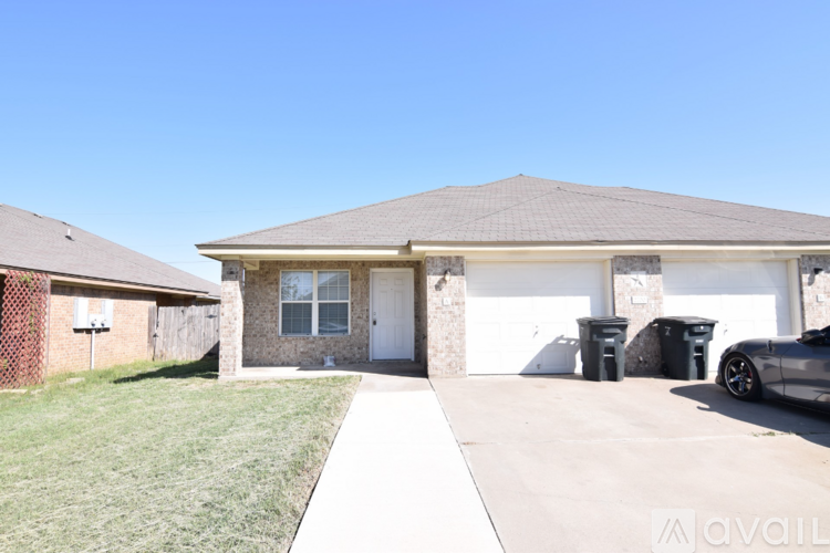 A house with a garage and a driveway in front.