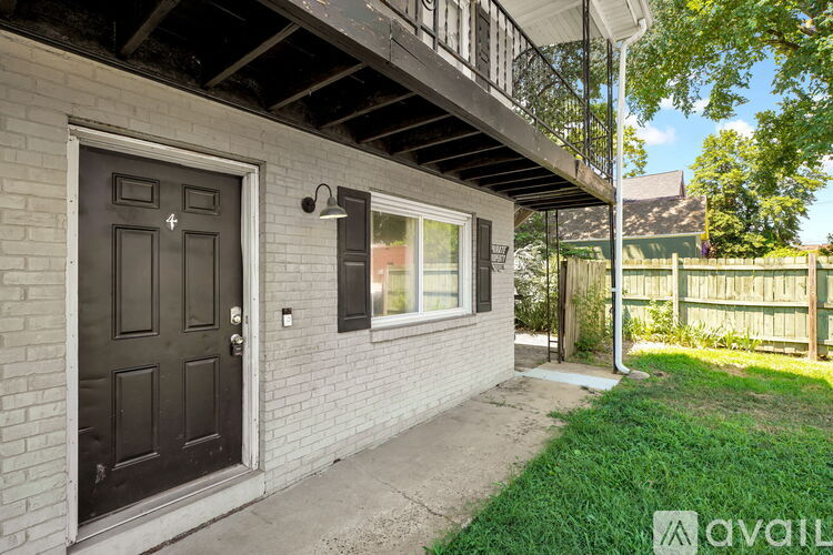 A house with a black door and a balcony.