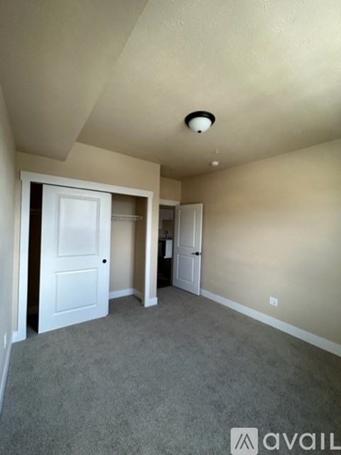 A room with a carpeted floor and a ceiling light.