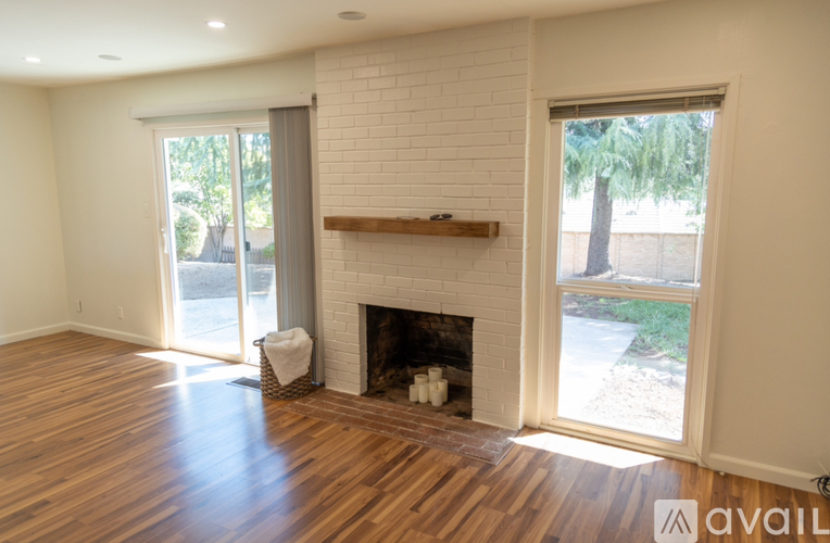 A living room with a fireplace and sliding glass doors.